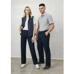 A man and woman stand together. The man wears grey polo and navy slacks; the woman wears a white t-shirt, navy vest, and navy trousers.