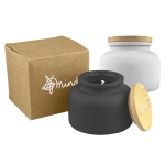 A black and white candle jar with a bamboo lid, presented alongside a recycled box. Features a logo.