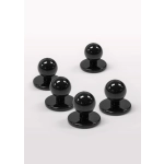 A set of five black chef jacket buttons with a round top and a flat base.