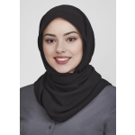 A black women's hijab worn by a smiling woman, featuring a smooth fabric and a simple style.