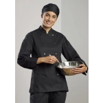 A black long sleeve chef jacket worn by a woman, who is holding a mixing bowl and whisk. The outfit includes a chef's hat.