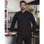 A black men's functional chef jacket, featuring a sleek design and a prominent logo, displayed in a kitchen setting.