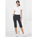 3/4 length stretch pants in black worn by a woman, featuring pockets and a sleek design. Model stands against a plain background.