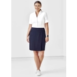 A model wears a white shirt and a navy women's comfort waist skort with buttons, featuring a sleek design.