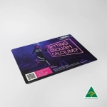 A counter mat featuring a vibrant design with a person and a logo, predominantly in dark colours.