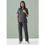 A model wearing black Women's Tokyo Scrub Pant paired with a matching top, featuring pockets and a logo.