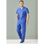 A man wearing a blue unisex scrub top and cargo pants, standing against a neutral background. The outfit includes a pocket.