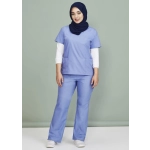 A model wearing light blue classic women's bootleg scrub pants paired with a matching scrub top and a navy hijab.