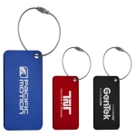 Three metallic luggage tags in blue, red, and black, each attached with a silver cable. All feature logos.