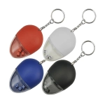 A drink bottle opener key ring in red, white, blue, and black, featuring a transparent section with small dice inside.