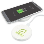 A round white wireless charger with a logo, beside a smartphone displaying a charging battery icon.