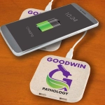 A wireless charger hub in a light-colored design, with a smartphone displaying a charging battery symbol.