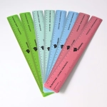 A collection of recycled plastic rulers in green, blue, and pink, featuring a logo and measurement markings.