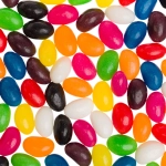 Assorted jelly beans in various colors including black, blue, orange, pink, yellow, green, and white.