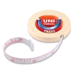 A beige tape measure with a circular casing and a retractable white measuring tape marked in red and black.
