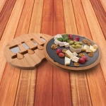 A bamboo cheese board with a slate surface, featuring assorted cheeses, olives, grapes, and walnuts. It includes knife slots.