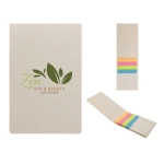 A tan sticky note pad with a logo, featuring colorful sticky flags in pink, orange, yellow, and green.