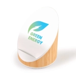 A wireless speaker and charger with a bamboo base and a circular white top featuring the logo "Green Energy."
