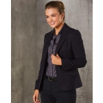 A cropped women's blazer in navy with a single button, paired with a dark shirt and sleek hairstyle.