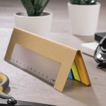A brown cardboard sticky note pad, featuring coloured notes in yellow, blue, and orange, shaped like a ruler.