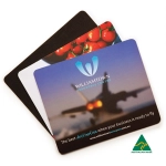 Three mouse mats featuring colourful designs, including images of tomatoes and an aircraft. One has a logo and branding.