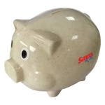 A beige piggy bank made from wheat straw, featuring large eyes and a logo on the side.
