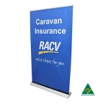 A blue roll-up banner featuring the RACV logo and text about caravan insurance, with an Australian Made emblem.