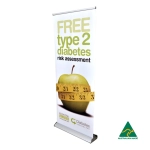 A deluxe 850mm roll-up banner featuring a green apple, a measuring tape, and a logo. Predominantly white and yellow.