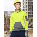 A bright yellow and grey two-tone hoodie featuring a front pocket and a logo, worn by a person in a construction setting.