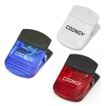 Three plastic magnetic clips in blue, red, and white, featuring a clip design and a logo on each.