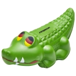 A green crocodile-shaped stress toy with textured skin and distinctive eyes. Features a logo on the side.
