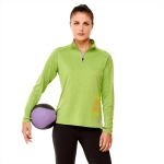 A green women's quarter zip jumper with long sleeves, featuring a logo and a model holding a medicine ball.