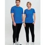 Two models wearing blue t-shirts and black poly/cotton terry sweat pants, standing side by side against a light background.