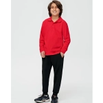 A boy wearing a red long-sleeve polo and black poly/cotton terry sweat pants, standing against a plain background.