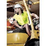 A man wearing a yellow and navy hi-vis short sleeve polo shirt operates a forklift, wearing a safety helmet.