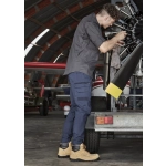 Mens Streetworx Heritage Pant in navy, paired with tan work boots, worn by a man repairing machinery in a hangar.