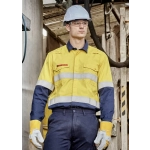 A man in a yellow and navy spliced work shirt with reflective stripes, wearing a hard hat and safety glasses.