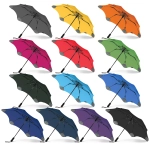 A set of BLUNT Metro Umbrellas in various colours including black, yellow, orange, pink, red, green, blue, navy, and purple.