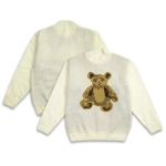 A cream knitted jumper featuring a teddy bear design on the back and a plain front. It includes a logo detail.