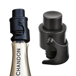 A champagne stopper in black, designed to seal bottles securely, featuring a logo on one side.