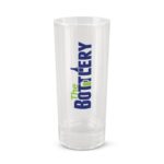 A clear glass shot glass with a printed logo that reads "The Bottlery" in bold letters.