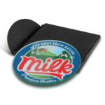A round, full-colour glass coaster with a milk-themed design, featuring a logo and a black base.