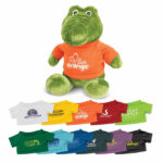 A green crocodile plush toy wearing a bright orange shirt, surrounded by various miniature T-shirts in different colours.